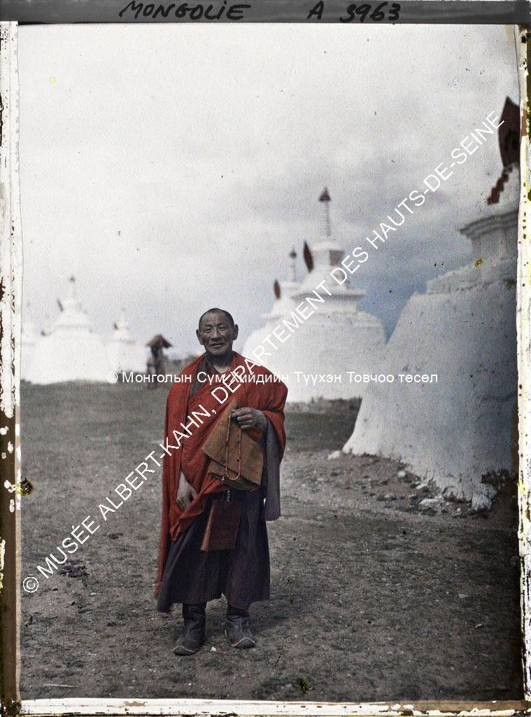 A monk standing among the stupas behind Gandan. Musée Albert-Kahn. A3963. Photo by Stéphane Passet, 23 July 1913
